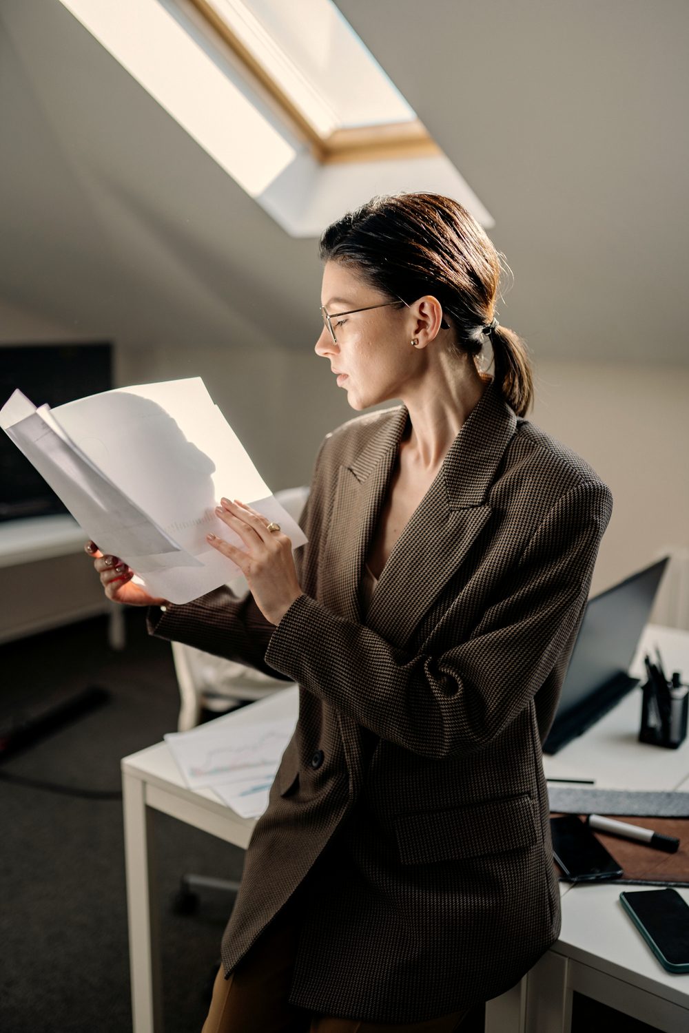 Going through credit report paperwork in a warm, sunlit office