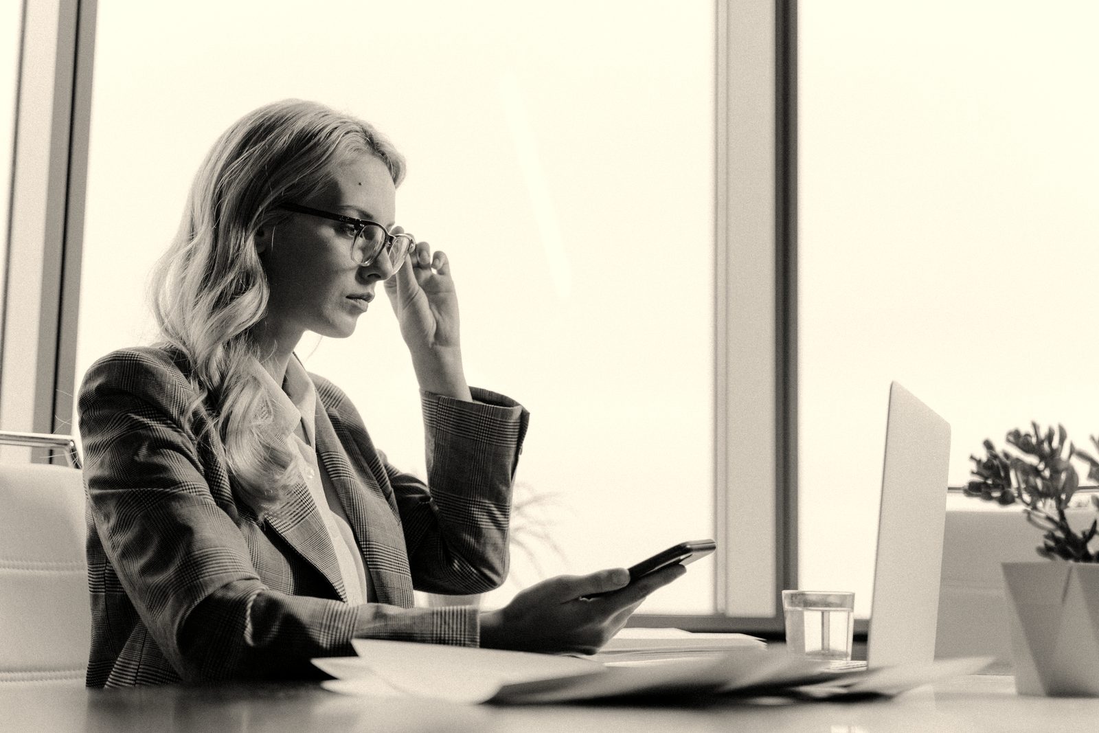 A woman at her desk going through her credit report and financial paperwork
